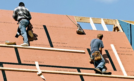 Workers Putting Roof on New Home